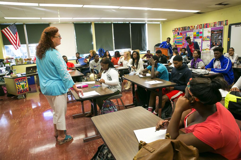 Jeanette Rousseau, known as “Miss J,” leads a class at Flint Southwestern Academy High School. She’s known as a tough-love teacher, but was Thomas Rawls’ favorite when he was in high school. “Every time I would talk to him about something I would equate it to football, because that’s what he knew,” she said. After he missed a qualifying score on a standardized test several times in a row that he needed to make it into the University of Michigan, she tutored him for two weeks straight to prepare. “That was his gateway for a scholarship to college,” she said. “I always tell my students – I can’t take credit for his success. I gave him the tools he needs to be successful – but I give every student in my classroom the tools they need to be successful.” (Bettina Hansen/The Seattle Times)