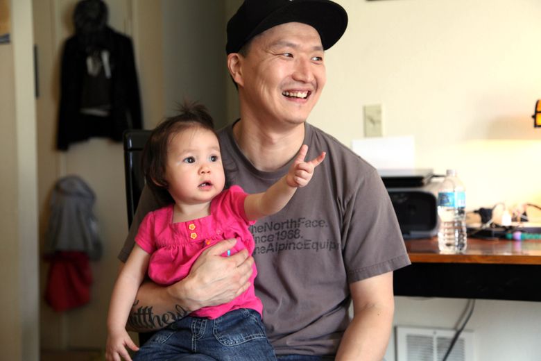 Adam Crapser with daughter, Christal, 1, in 2015 in the family’s home in Vancouver, Wash.  Crapser, a South Korean man who was flown to the U.S. 37 years ago and adopted by an American couple at age 3 has been ordered deported back to a country that is completely alien to him. (AP Photo/Gosia Wozniacka, file)