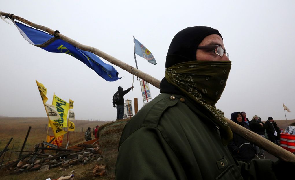 A Kickapoo Nation tribal member from Kansas. Despite the turmoil of the past week, the scene in the camp often resembles a reunion by tribes who have not gathered in these numbers in North America in more than a century. (Alan Berner/The Seattle Times)
