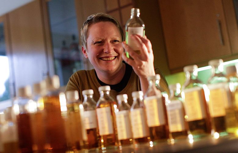 Emma Walker, a whisky specialist and blender at Diageo Plc, holds a sample bottle of single malt, single grain whisky as she poses for a photograph in the Spirit Mastery Room in the Diageo technical center near Stirling, U.K., on Thursday. Sept. 29, 2016. Johnnie Walker, made by Diageo Plc, accounts for about one in every 10 bottles of Scotch consumed across the world. Photographer: Matthew Lloyd/Bloomberg