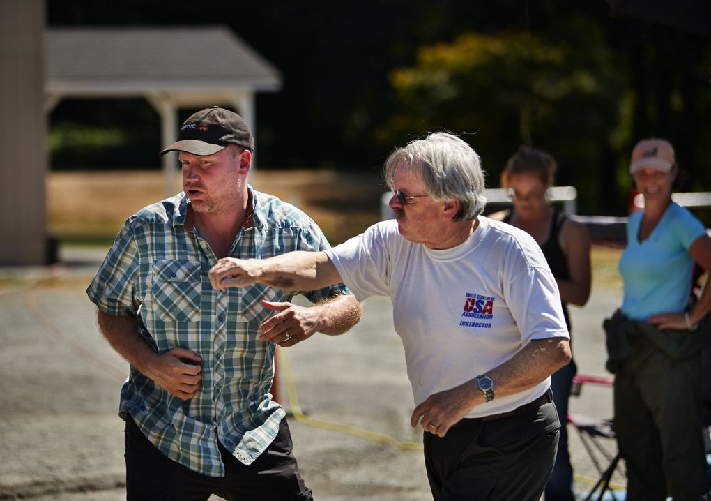 David Boushey, right, the founder of the International Stunt School, throws a fake punch at longtime ISS instructor Daniel Ford Beavis. (Benjamin Benschneider/The Seattle Times)