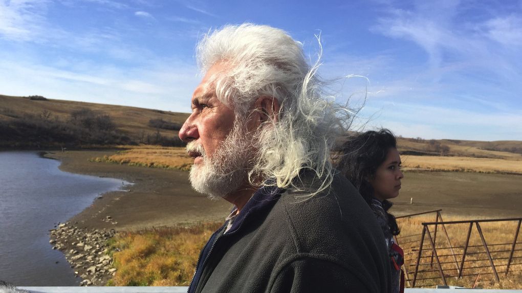 Miles Allard, a Turtle Mountain Chippewa elder, negotiated a pullback of both sides on the Highway 1806 bridge north of the main camp on Friday. “The only way we’re going to win this is by prayer,” he said. (Alan Berner/The Seattle Times)