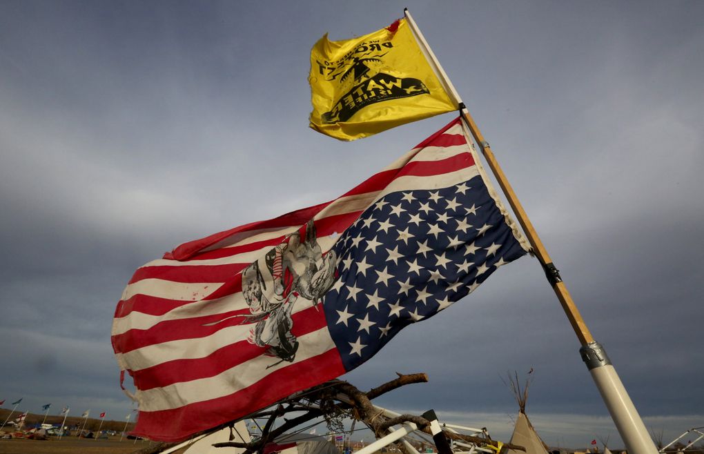 Many flags in the main encampment fly upside down, indicating distress. (Alan Berner/The Seattle Times)