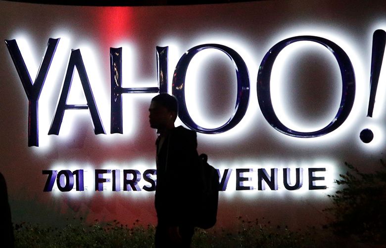 FILE – In this Nov. 5, 2014, file photo, a person walks in front of a Yahoo sign at the company’s headquarters in Sunnyvale, Calif. Verizon bought Yahoo in a sale announced Monday, July 25, 2016. (AP Photo/Marcio Jose Sanchez, File)