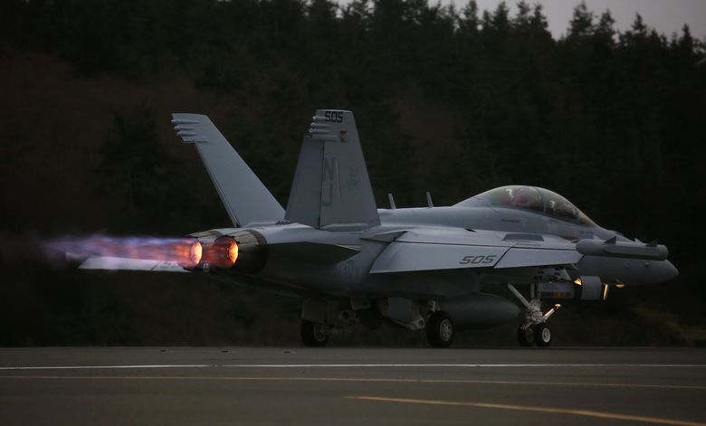 An EA-18G Growler engine&#8217;s thrust with afterburner propels its takeoff with a loud roar from Naval Air Station Whidbey Island during an exercise.  (Ken Lambert / The Seattle Times)