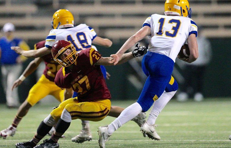 O’Dea’s Parker Dana tackles Ferndale’s James Hinson on a kickoff return at Memorial Stadium on Friday, Nov. 11, 2016