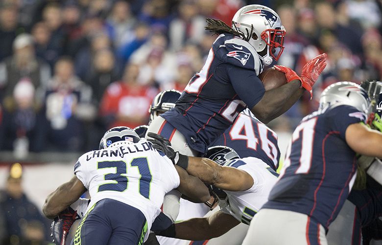 Seattle Seahawks safety Kam Chancellor (31) leaps to stop New England Patriots running back LeGarrette Blount (29) from scoring a touchdown over the pile during the fourth quarter of the game, Sunday, November 13, 2016 at Gillette Stadium in Foxborough, MA.