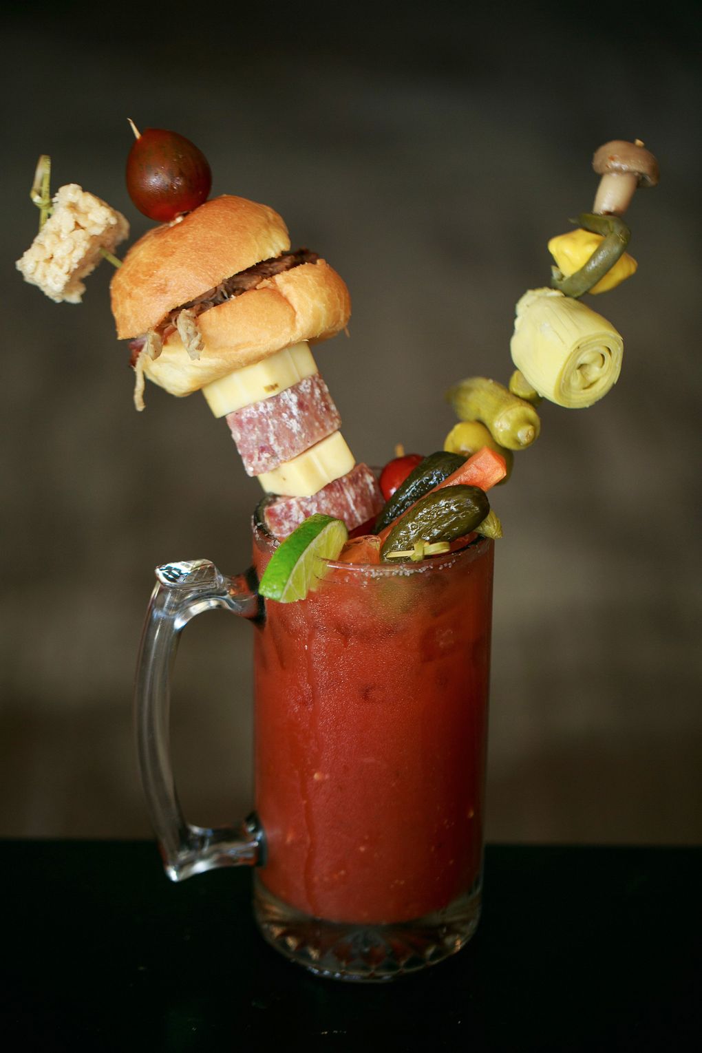 Besides lutefisk tacos, the Slippery Pig Brewery in Poulsbo offers a loaded Bloody Mary, which comes with a pulled-pork slider speared on a swizzle stick, along with salami, pepperjack cheese, sweet pickle, okra and several other veggies, all in a 22-ounce mug. (Erika Schultz/The Seattle Times)