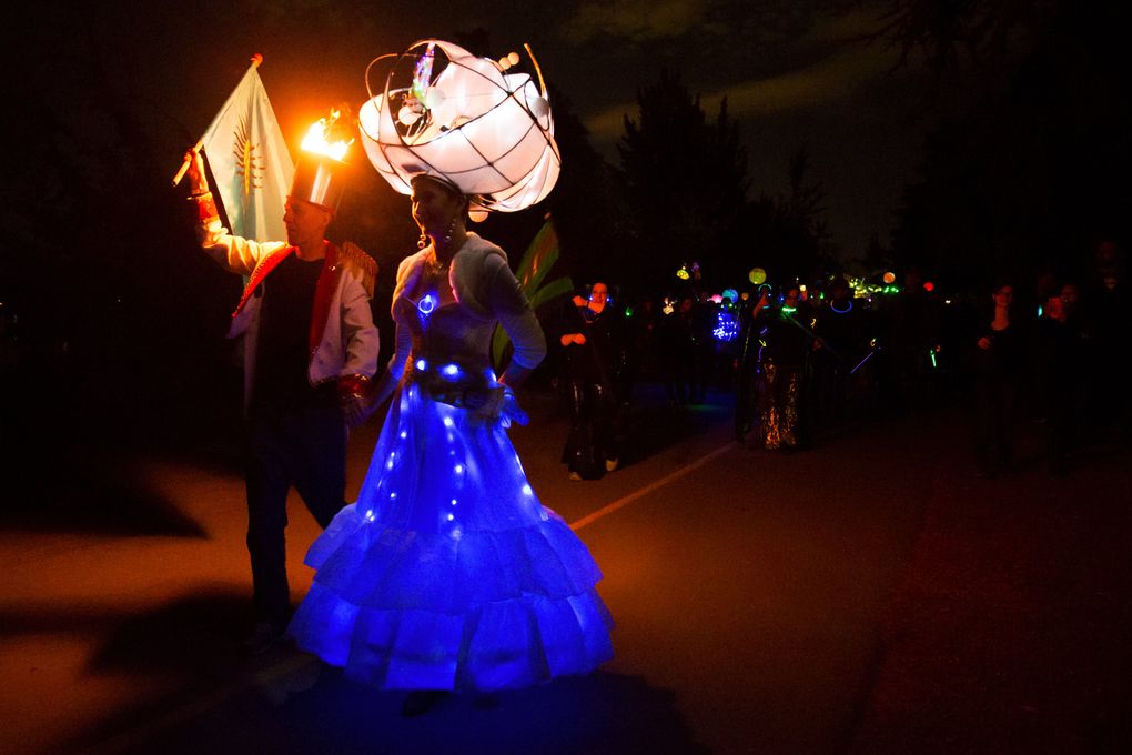 Peter Toms and Marina McDonagh walk in the Luminata lantern parade, which is held annually at Green Lake on the evening of the autumnal equinox. (Erika Schultz/The Seattle Times)