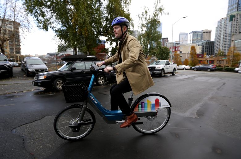 SDOT’s Andrew Glass Hastings demonstrates an electric bike that possibly could be part of a new Pronto rollout  (Ken Lambert/The Seattle Times)