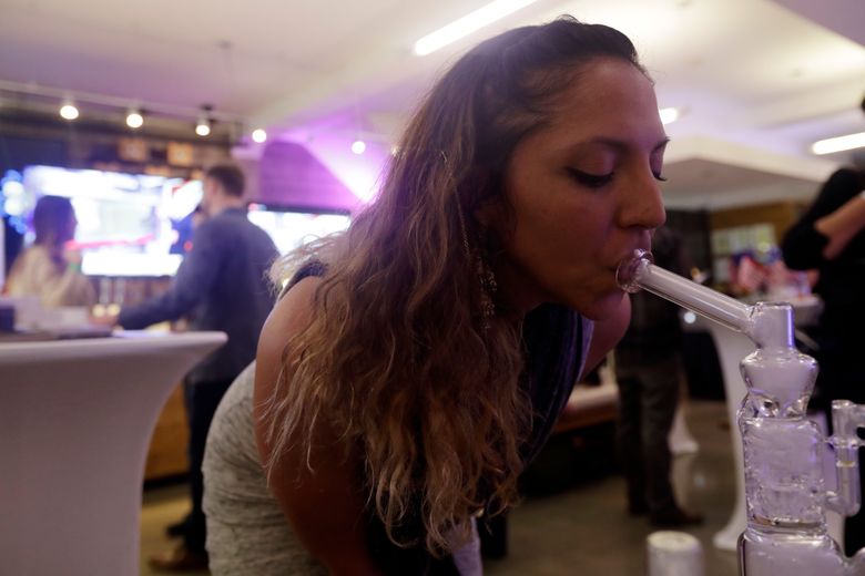 Krystal Xiques smokes marijuana at a rally in support of Prop 64 at Sparc Dispensary Tuesday, Nov. 8, 2016, in San Francisco. California voters approved a ballot measure Tuesday allowing recreational marijuana in the nation’s most populous state. (AP Photo/Marcio Jose Sanchez)