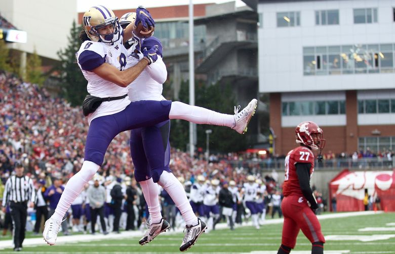 Washington’s Dante Pettis and John Ross celebrate Pettis’ touchdown in the first quarter to put the Huskies up 14-0 over Washington State during  the 109th Apple Cup at Martin Stadium in Pullman, Wash. on Friday, Nov. 25, 2016.