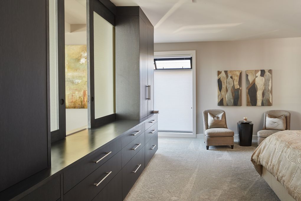 The translucent-glass pass-through between the master bedroom and the living area is “open for us most all the time,” says homeowner Rhonda Nelsen. (Benjamin Benschneider/The Seattle Times)