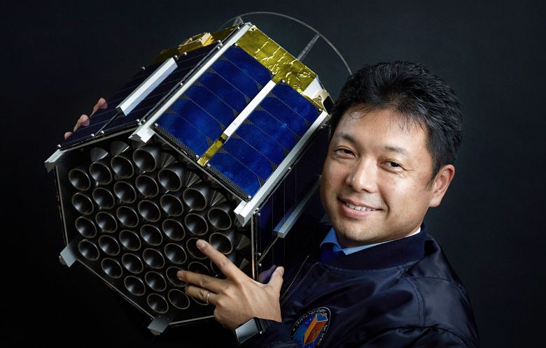 Mitsunobu Okada, CEO of Astroscale, poses with a concept model of space-debris capturing satellite ADRAS 1 at its factory in Tokyo, Oct. 31, 2016. Astroscale is a start-up dedicated to cleaning up some of humanityÕs hardest-to-reach rubbish, and its plans include a small satellite with an adhesive glue. (Ko Sasaki/The New York Times)
