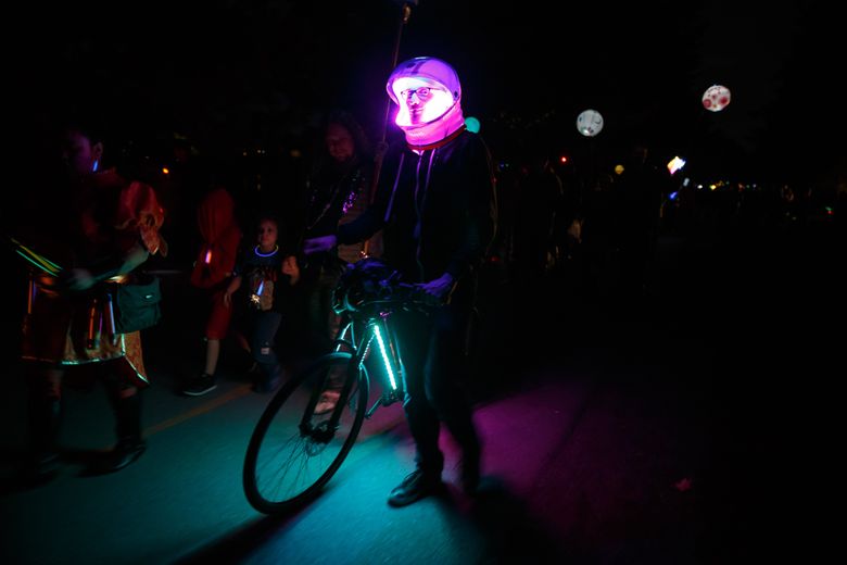 Zee McManus walks in the annual Luminata lantern parade organized by the Fremont Arts Council at Green Lake. The event celebrates the autumnal equinox and the shift from summer into a time of darkness and introspection. (Erika Schultz/The Seattle Times)