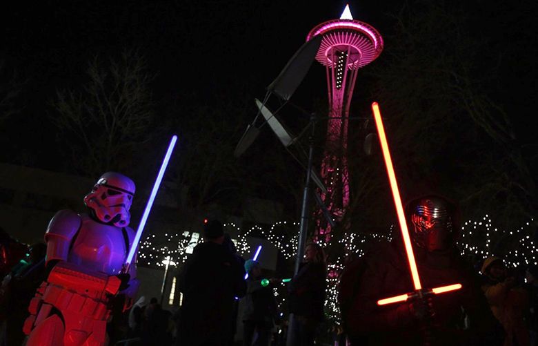 Storm Trooper and Kyli Ren pose for portraits at Fischer Pavilion in Seattle Center for a lightsaber vigil on Friday, December 30, 2016. The vigil honors the death of Carrie Fisher who famously played Princess Leia in the series.