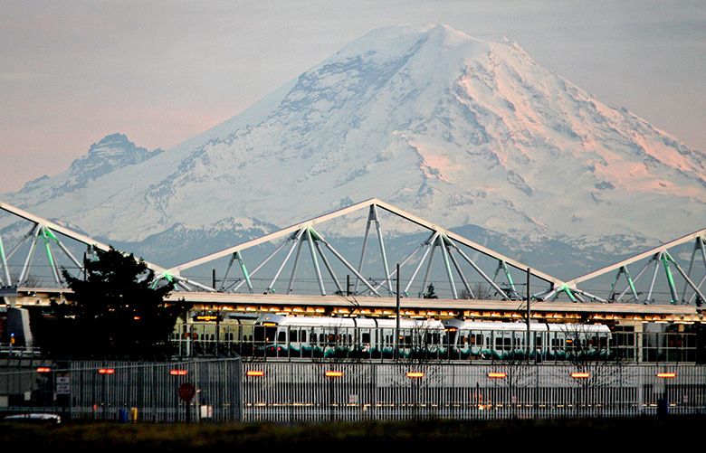 LINK LIGHT RAIL — SEATAC/AIRPORT  STATION — 12112009 — 99999

  The link light rail Seatac/Airport station  opens December 19.  The station provides a direct pedestrian connection to the airport terminal–about 1,000 feet or a four-minute walk away.  Mt. Rainier looms in the background at dusk, one recent evening.