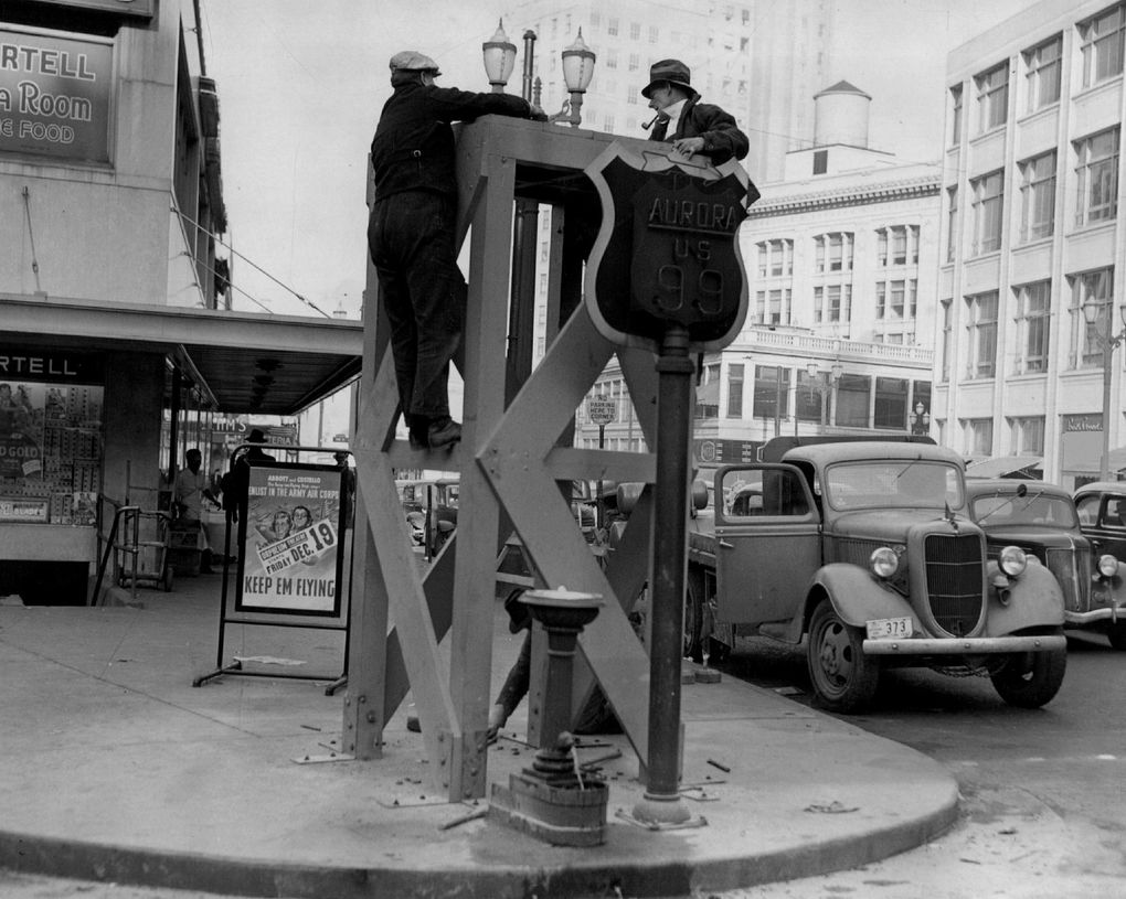In December 1941, workers install the base for an air-raid siren at Fourth Avenue and Pine Street. (Seattle Times)