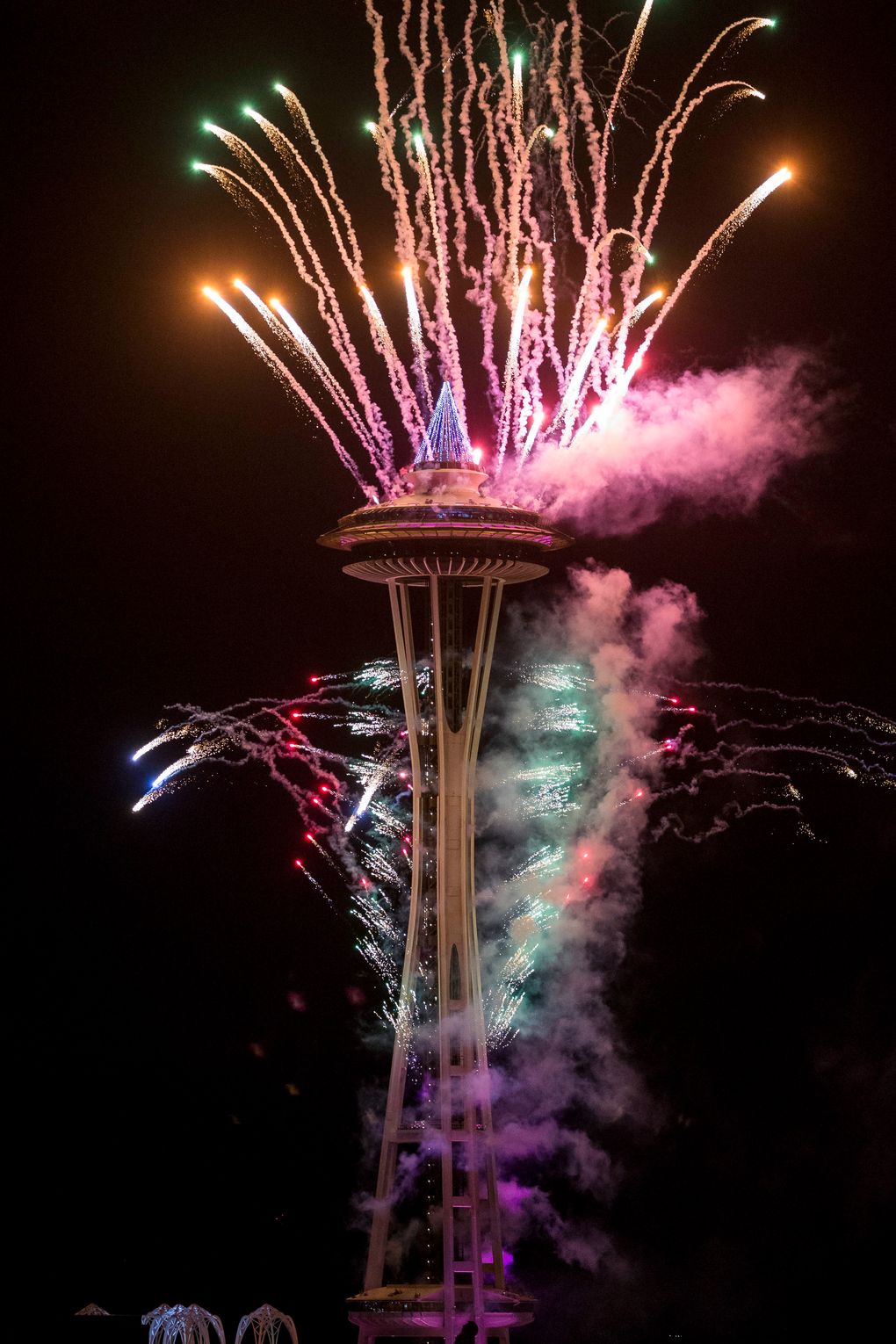 The first minutes of 2017 are celebrated with fireworks shot off of and around the Space Needle, as seen from the roof of Mbar restaurant on Sunday, January 1, 2017. (Logan Reily / The Seattle Times)
