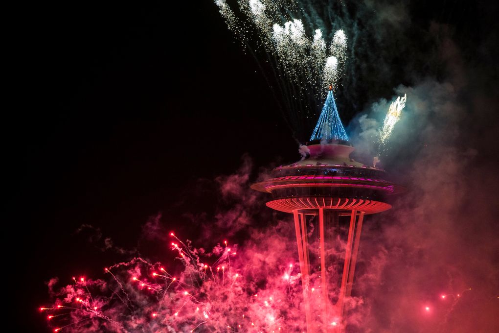 The first minutes of 2017 are celebrated with fireworks shot off of and around the Space Needle, as seen from the roof of Mbar restaurant on Sunday, January 1, 2017. (Logan Reily / The Seattle Times)