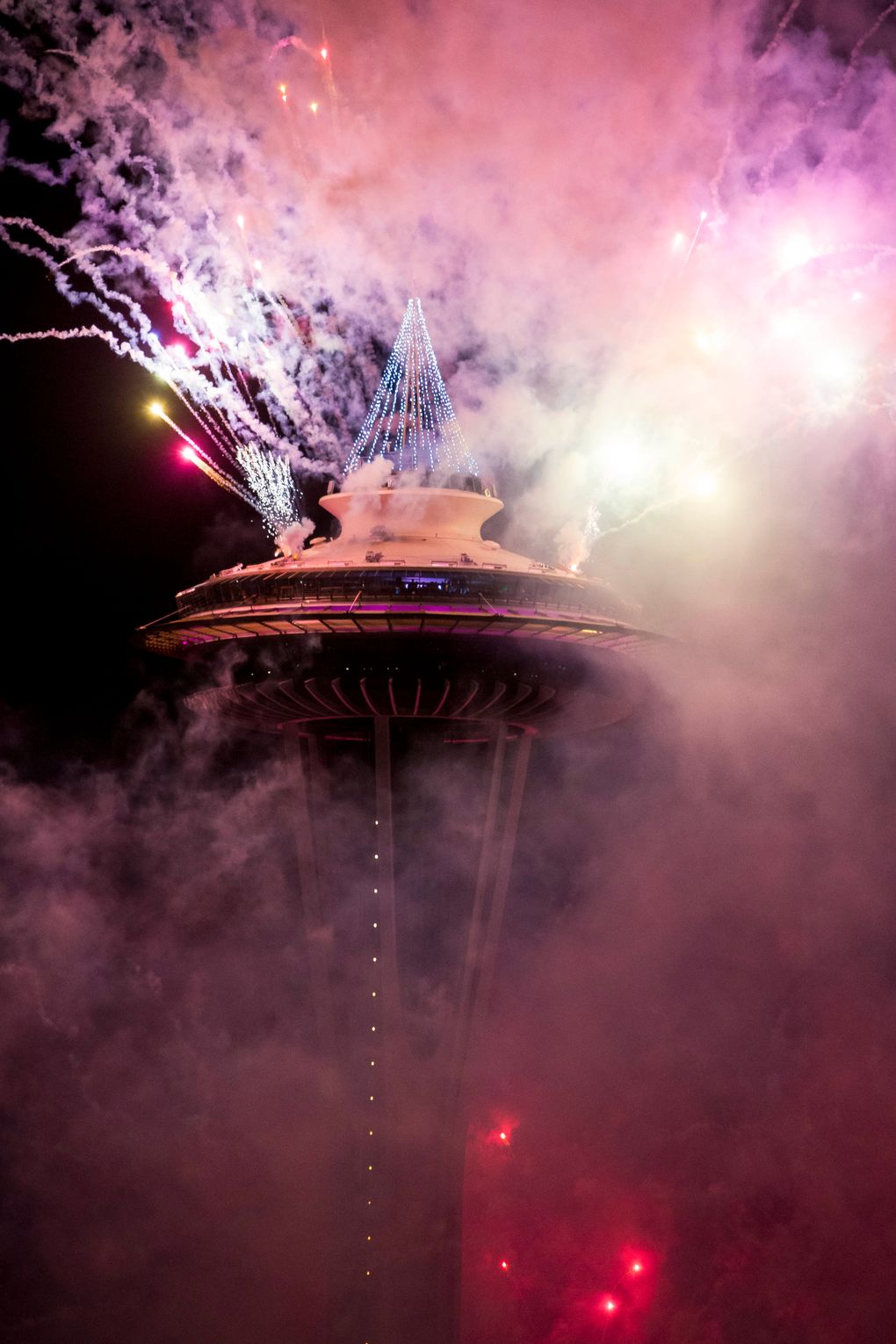 The first minutes of 2017 are celebrated with fireworks shot off of and around the Space Needle, as seen from the roof of Mbar restaurant on Sunday, January 1, 2017. (Logan Reily / The Seattle Times)