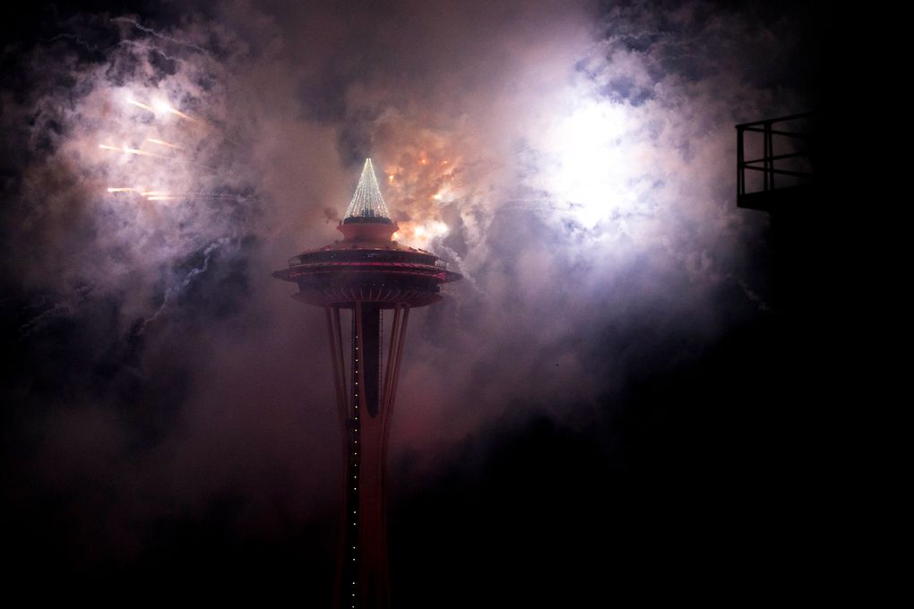 The first minutes of 2017 are celebrated with fireworks shot off of and around the Space Needle, as seen from the roof of Mbar restaurant on Sunday, January 1, 2017. (Logan Reily / The Seattle Times)