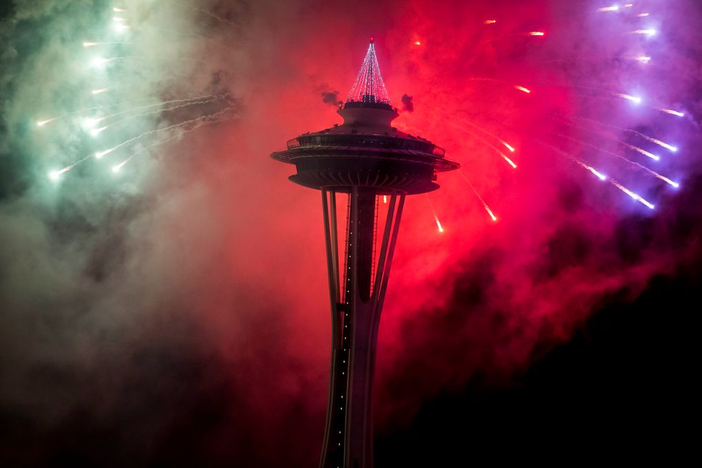 The first minutes of 2017 are celebrated with fireworks shot off of and around the Space Needle, as seen from the roof of Mbar restaurant on Sunday, January 1, 2017. (Logan Reily / The Seattle Times)