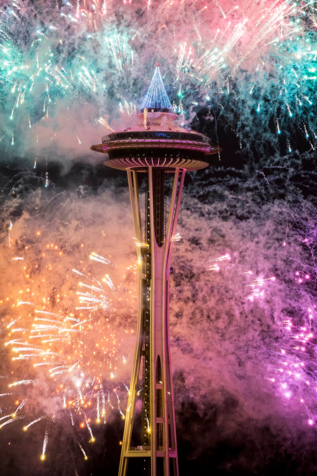 The first minutes of 2017 are celebrated with fireworks shot off of and around the Space Needle, as seen from the roof of Mbar restaurant on Sunday, January 1, 2017. (Logan Reily / The Seattle Times)
