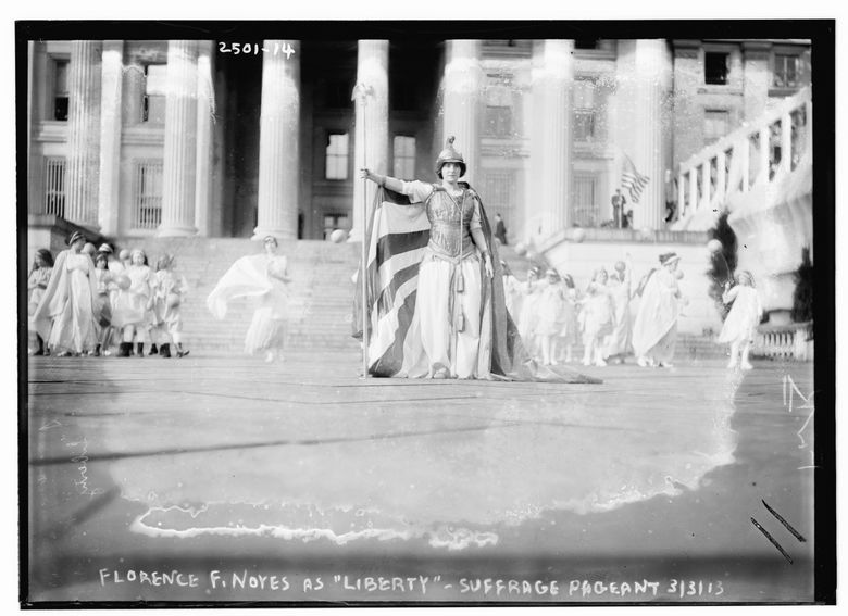 In this photo provided by the Library of Congress, taken in 1913, German actress Hedwig Reicher wearing costume of “Columbia” with other suffrage pageant participants standing in background in front of the Treasury Building in Washington. Thousands of women take to the streets of Washington, demanding a greater voice for women in American political life as a new president takes power. This will happen on Saturday, Jan. 21, 2017, one day after the inauguration of Donald Trump. This DID happen more than 100 years ago, one day before the inauguration of Woodrow Wilson. (Library of Congress via AP)