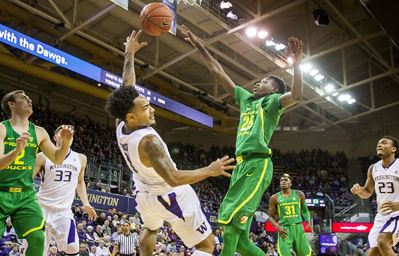 David Crisp looks to kick out the offensive board, but can’t get it over the reach of Oregon’s Chris Boucher in the 1st half.  The University of Oregon men’s basketball team played the University of Washington Wednesday, January 4, 2016 at Alaska Airlines Arena in Seattle.