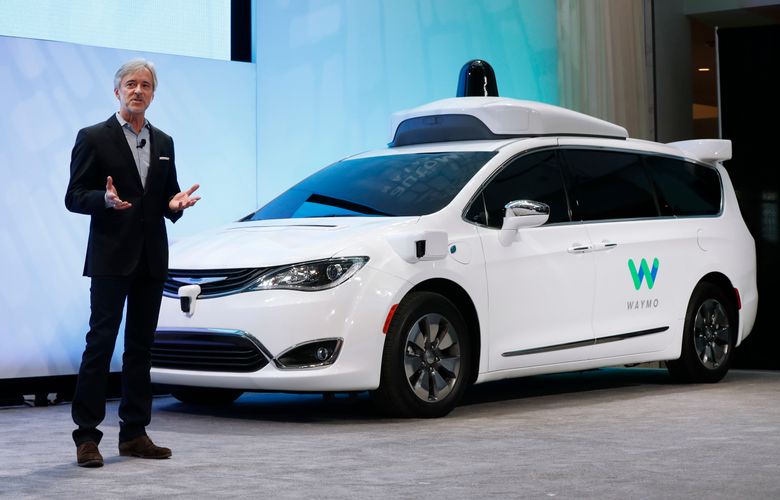 John Krafcik, CEO of Waymo, the autonomous vehicle company created by Google’s parent company, Alphabet introduces a Chrysler Pacifica hybrid outfitted with Waymo’s own suite of sensors and radar at the North American International Auto Show in Detroit, Sunday, Jan. 8, 2017. (AP Photo/Paul Sancya)