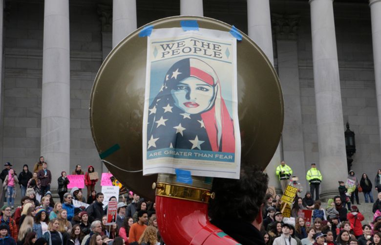 Protesters marking Inauguration Day gather on the steps of the state Capitol in Olympia, Washington on Friday, Jan. 20, 2017. (AP Photo/Rachel La Corte)