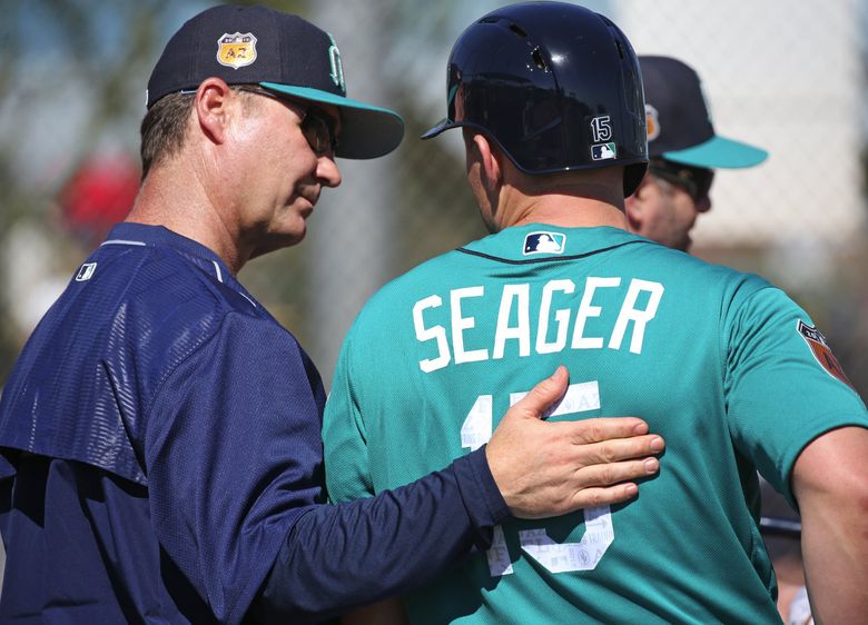 Manager Scott Servais, left, confers with third baseman Kyle Seager during a live batting practice at Mariners spring training, Tuesday, Feb. 21, 2017, in Peoria, Ariz.  (Ken Lambert / The Seattle Times)