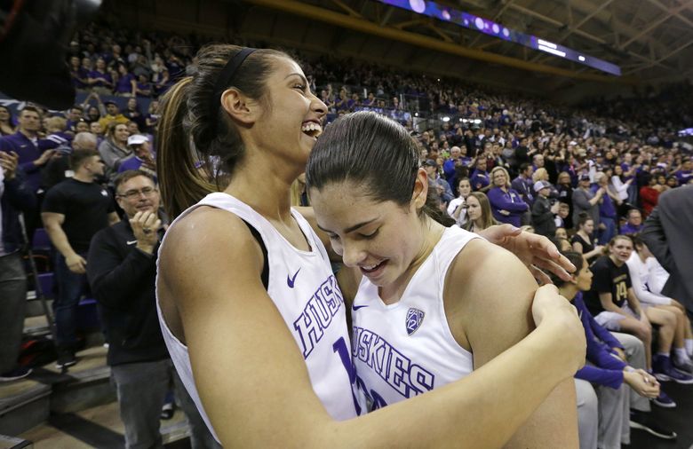 Washington’s Kelsey Plum, right, is greeted by Heather Corral as Plum leaves the game late in the second half. (AP Photo/Elaine Thompson) 