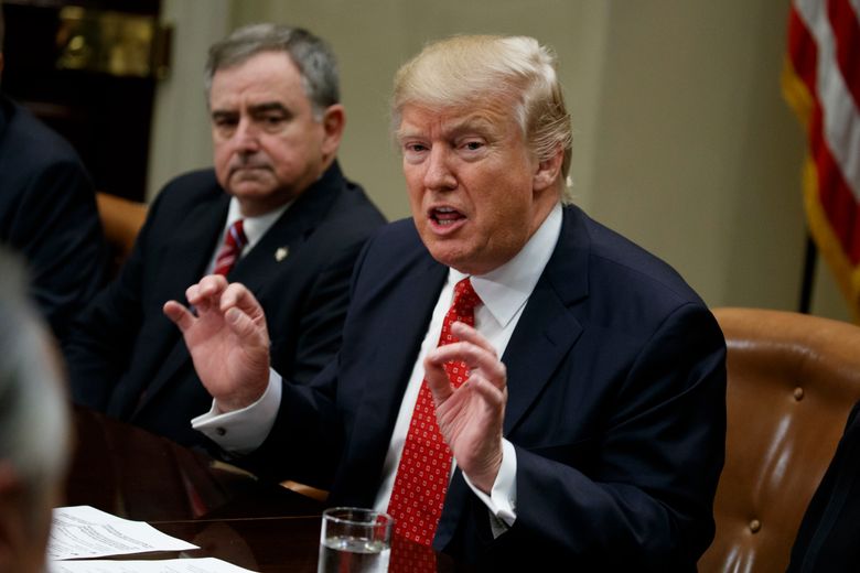 St. Charles, La. Parish Sheriff Greg Champagne, the president of the National Sheriffs Association listens at left as President Donald Trump speaks during a meeting with county sheriffs in the Roosevelt Room of the White House in Washington, Tuesday, Feb. 7, 2017. (AP Photo/Evan Vucci)