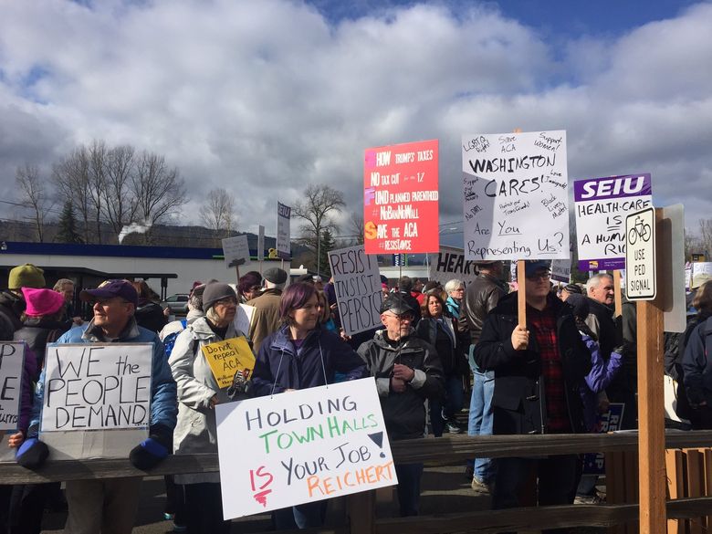 Protesters gather near U.S. Rep. Dave Reichert’s Issaquah office on Thursday. (Jim Brunner/The Seattle Times)