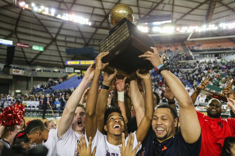Nathan Hale head coach Brandon Roy, right, celebrates with PJ Fuller, center, Keegan Crosby, left, and the rest of the team after their victory. (Johnny Andrews / The Seattle Times)