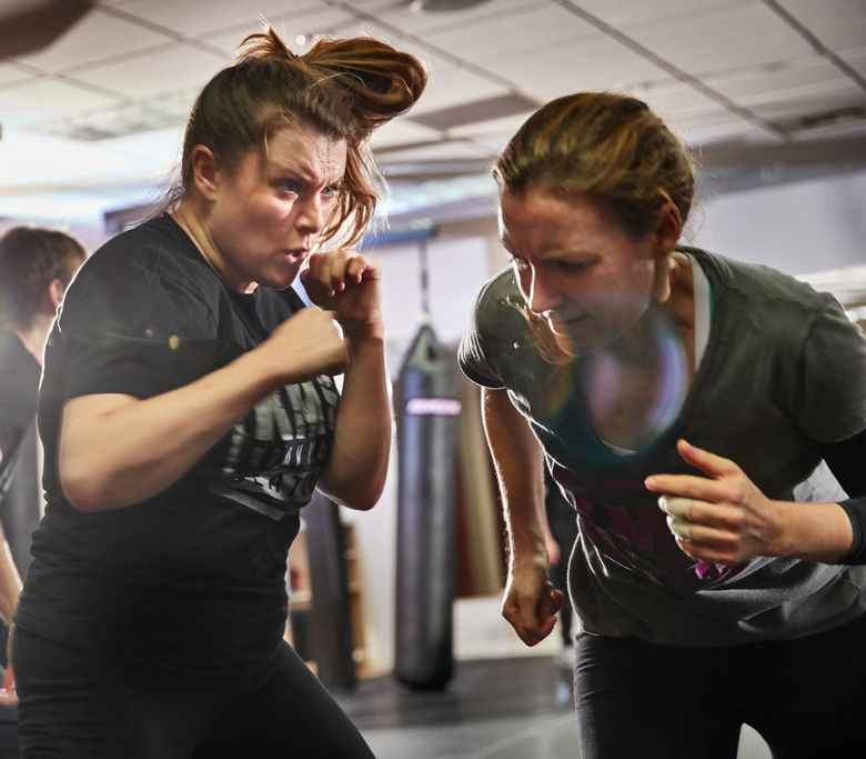 Woman makes a choke hold in self-defense training Stock Photo