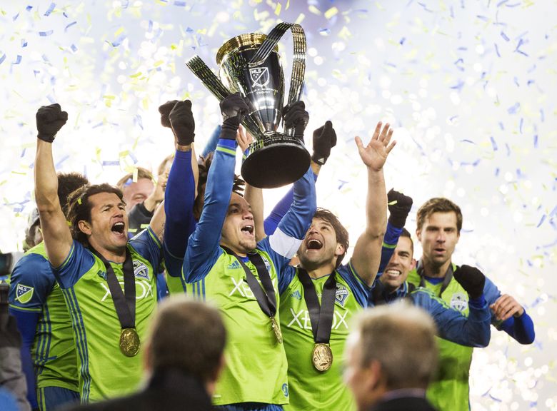 Seattle Sounders midfielder Osvaldo Alonso holds up the Philip F. Anschutz Trophy as the Sounders celebrate winning the MLS Cup at BMO Field in Toronto on Saturday, Dec. 10, 2016.   (Lindsey Wasson / The Seattle Times)