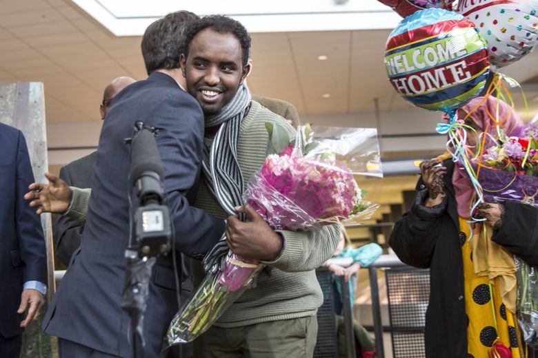 Attorney General Bob Ferguson greets Isahaq Ahmed Rabi, a Somali immigrant whose arrival in Washington was delayed by President Trump’s original travel order. Ferguson’s office led legal efforts to have that order blocked.  (Bettina Hansen / The Seattle Times)