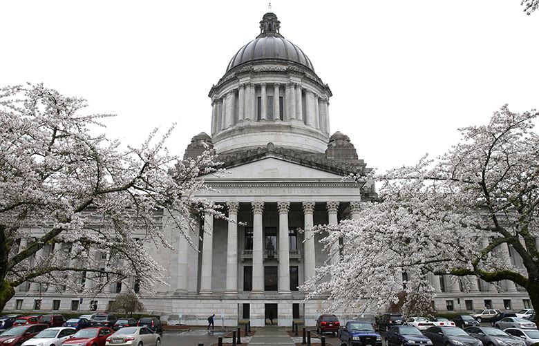 Trees are in bloom against a cloudy sky in front of the Legislative Building, Wednesday, March 9, 2016, at the Capitol in Olympia, Wash. Thursday is the final day of the regular session of the Legislature. (AP Photo/Ted S. Warren)