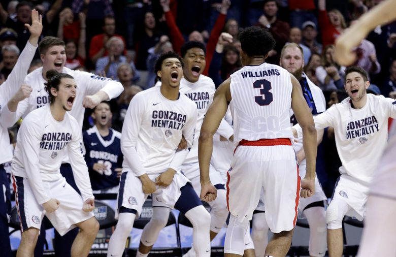 Gonzaga forward Johnathan Williams (3) celebrates with teammates after dunking against Xavier during the second half on Saturday. (Ben Margot/AP)
