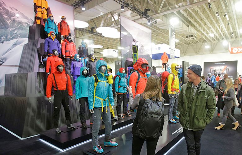 In this Wednesday, Jan. 11, 2017, photo, people attend the Outdoor Retailer show at the Salt Palace Convention Center in Salt Lake City. Footwear’s position as the second largest segment within the lucrative outdoor retail industry is on full display at a trade expo in Salt Lake City this week with a wide array of colorful sandals, shoes and boots that companies promise are lighter and can be used for more activities. (AP Photo/Rick Bowmer)