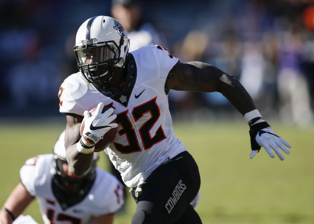 Oklahoma State running back Chris Carson (32) runs with the ball against TCU during the second half of an NCAA college football game, Saturday, Nov. 19, 2016, in Fort Worth, Texas. Oklahoma State won 31-6. (AP Photo/Jim Cowsert)