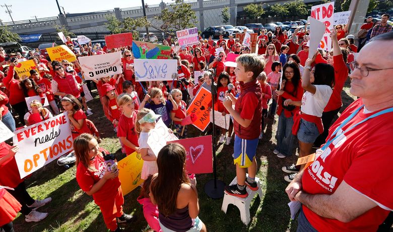 A student speaks as parents and others rally before the school board meeting to protest against two school closure proposals in Seattle on Wednesday, September 18, 2024. The rally is organized by All Together for Seattle Schools.