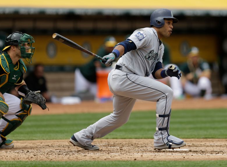 Seattle Mariners' Robinson Cano swings at a pitch in front of