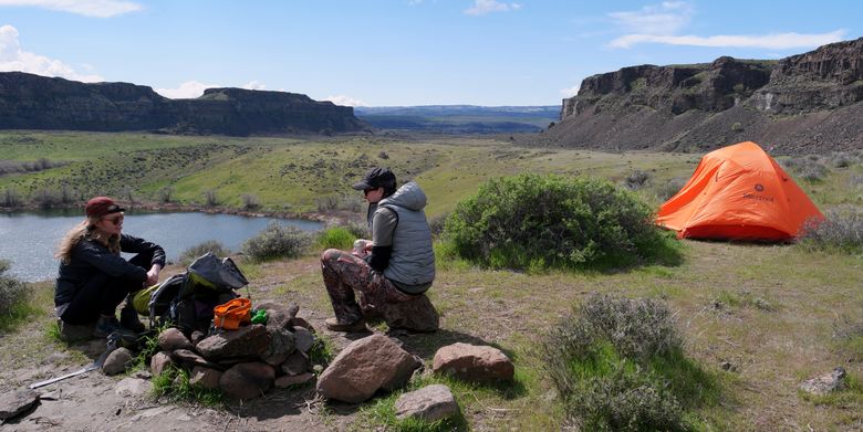 Valerie Madas, of Seattle, left, and Morgan Kemp, visiting from Illinois, relax after setting up camp at Ancient Lakes. Soak up the Grant County sunshine in coulee country. It’s a great destination for a day hike, or you can camp for the night. (Caitlin Moran)