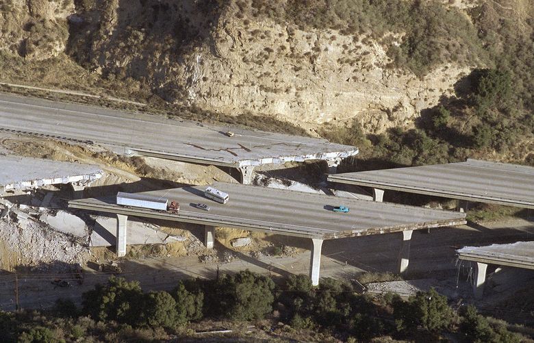 A tractor trailer and camper are abandoned on a span of eastbound state Route 14 near Sylmar, Calif., Tuesday morning Jan. 18, 1994 after a second portion of the interstate collapsed overnight in the wake of Monday’s major earthquake that struck the Southern California area. (AP Photo/Doug Pizac)