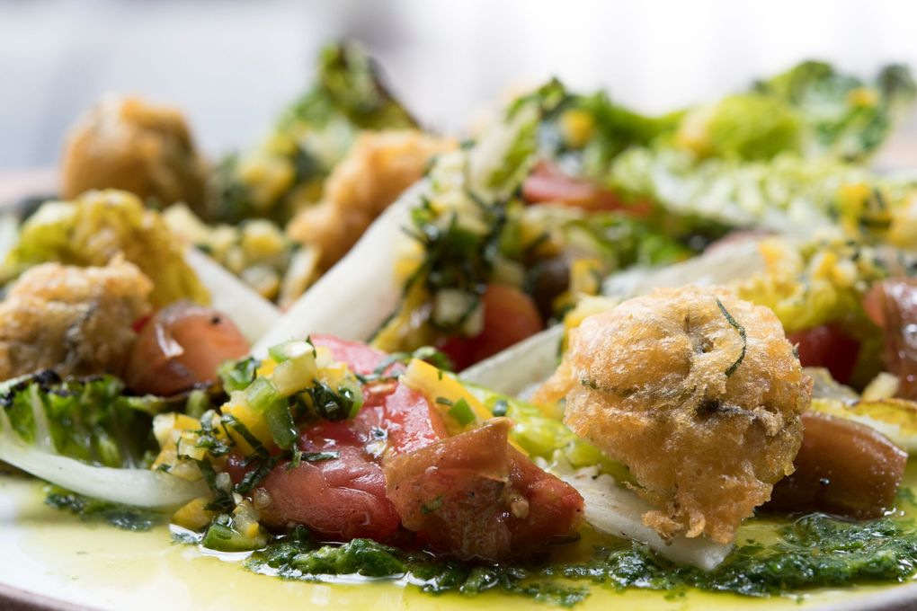 Crispy Hamma Hamma oysters with heirloom tomatoes, mustard green pesto and grilled romaine photo courtesy of Jason Wilson, executive chef and owner of Miller’s Guild, The Lakehouse, Civility & Unrest; executive chef and creative director at Coffee Flour; and culinary director at El Gaucho Hospitality.