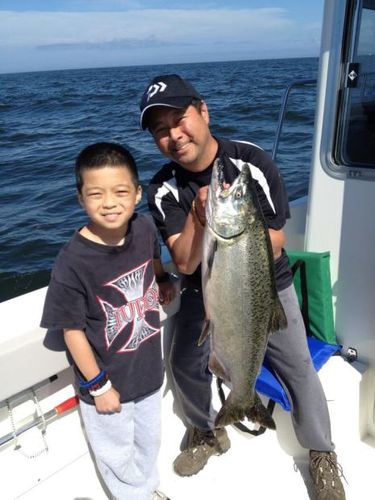Seattle Times fishing reporter Mark Yuasa with his son Tegan holding up a king salmon he caught off Long Beach near Ilwaco.
